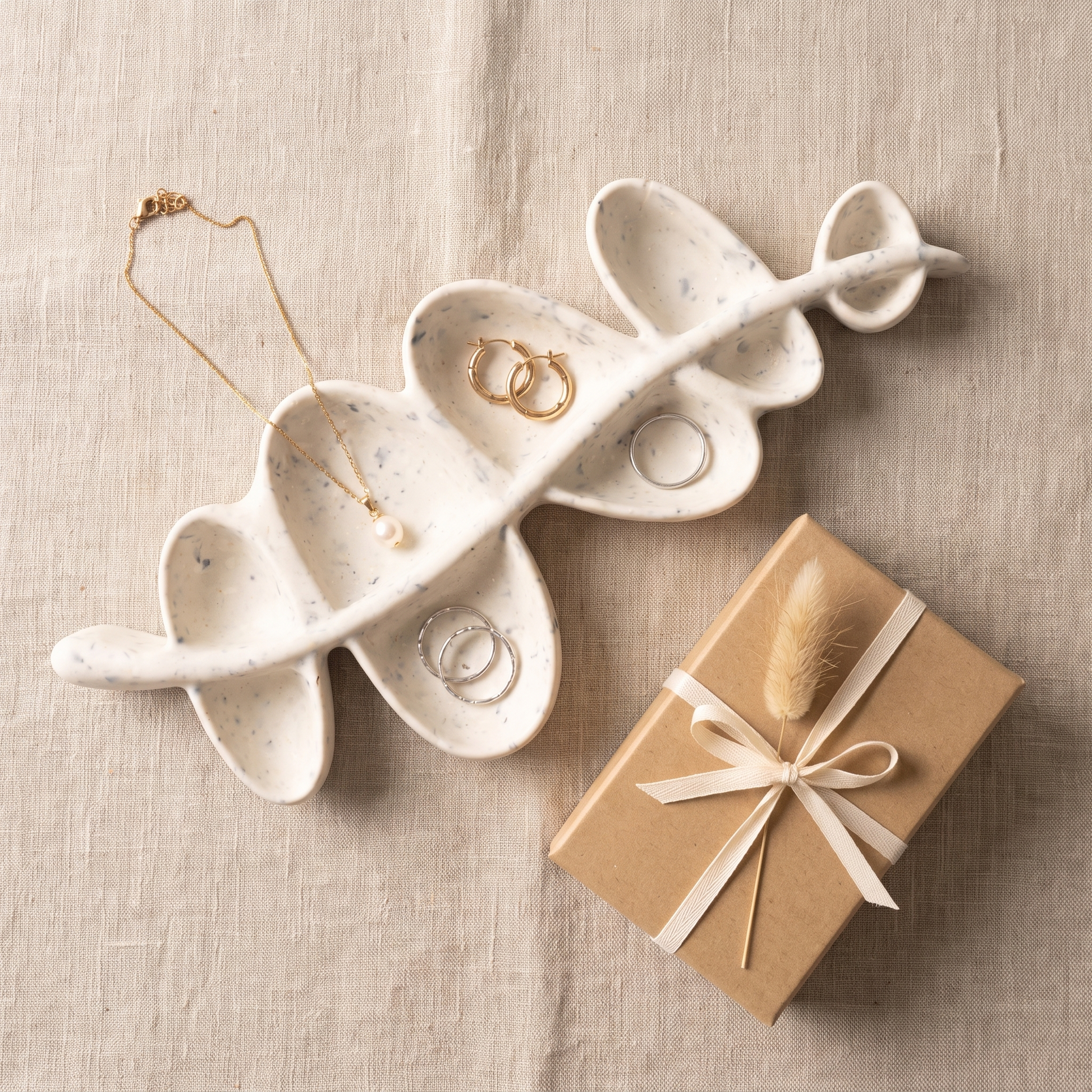Porte-bijoux branche d’olivier présenté avec des bijoux et un coffret cadeau